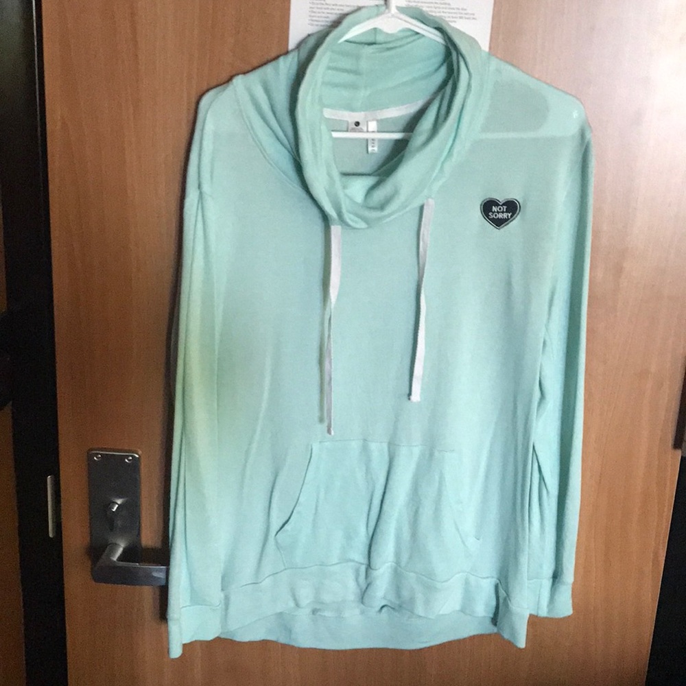 Light blue sweater with not sorry heart.